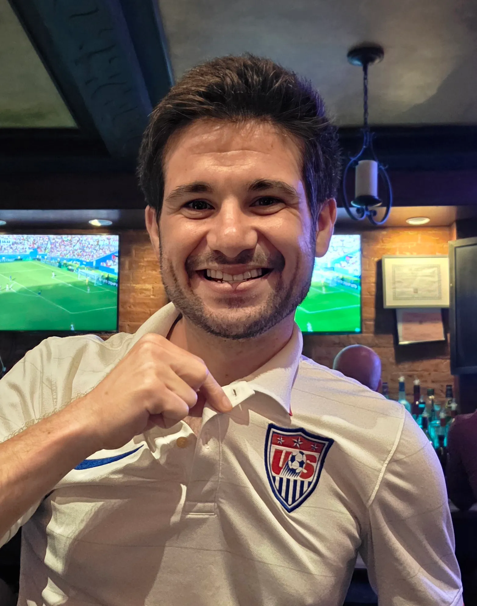 Jack Maguire at a bar watching a World Cup match in a USA jersey