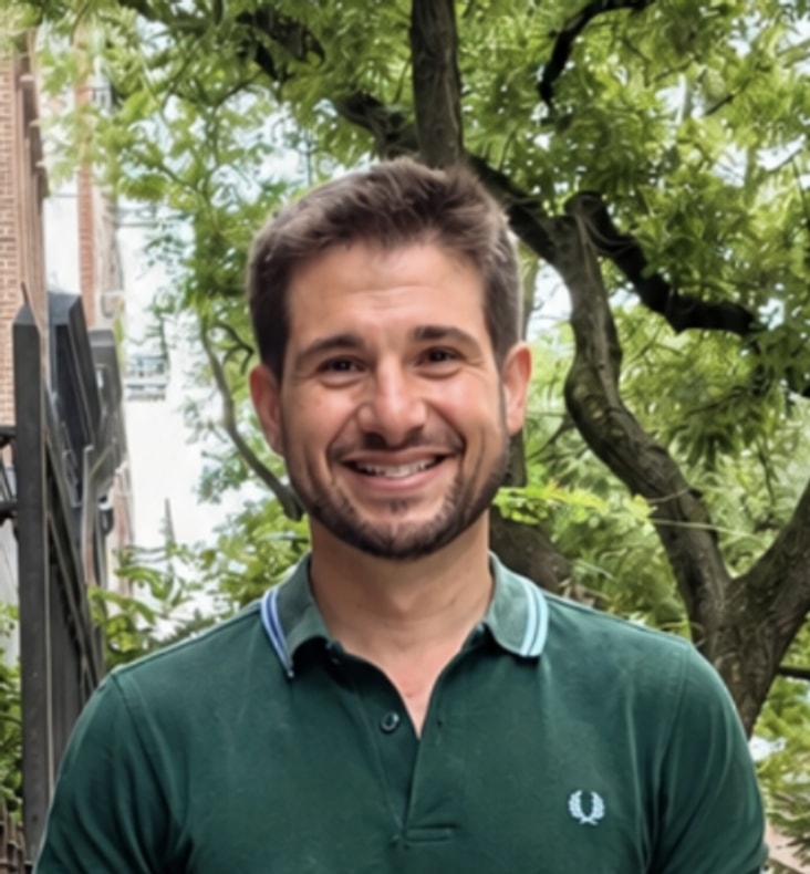 Jack Maguire smiling outdoors in New York City