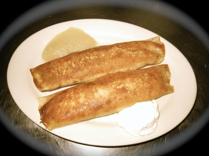 Two browned cheese blintzes with sour cream and applesauce at Polonica.
